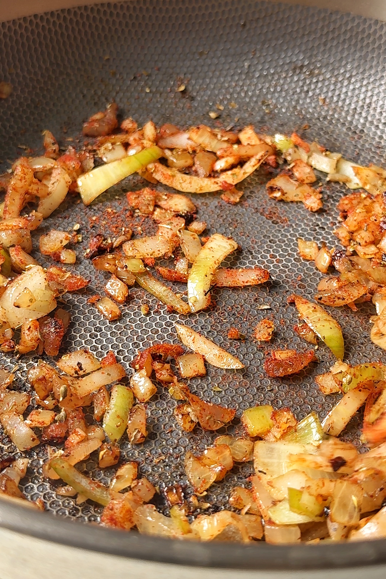 Frying onions and garlic in a pan.