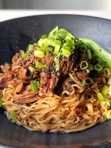 black ramen bowl with beef and ramen noodles.