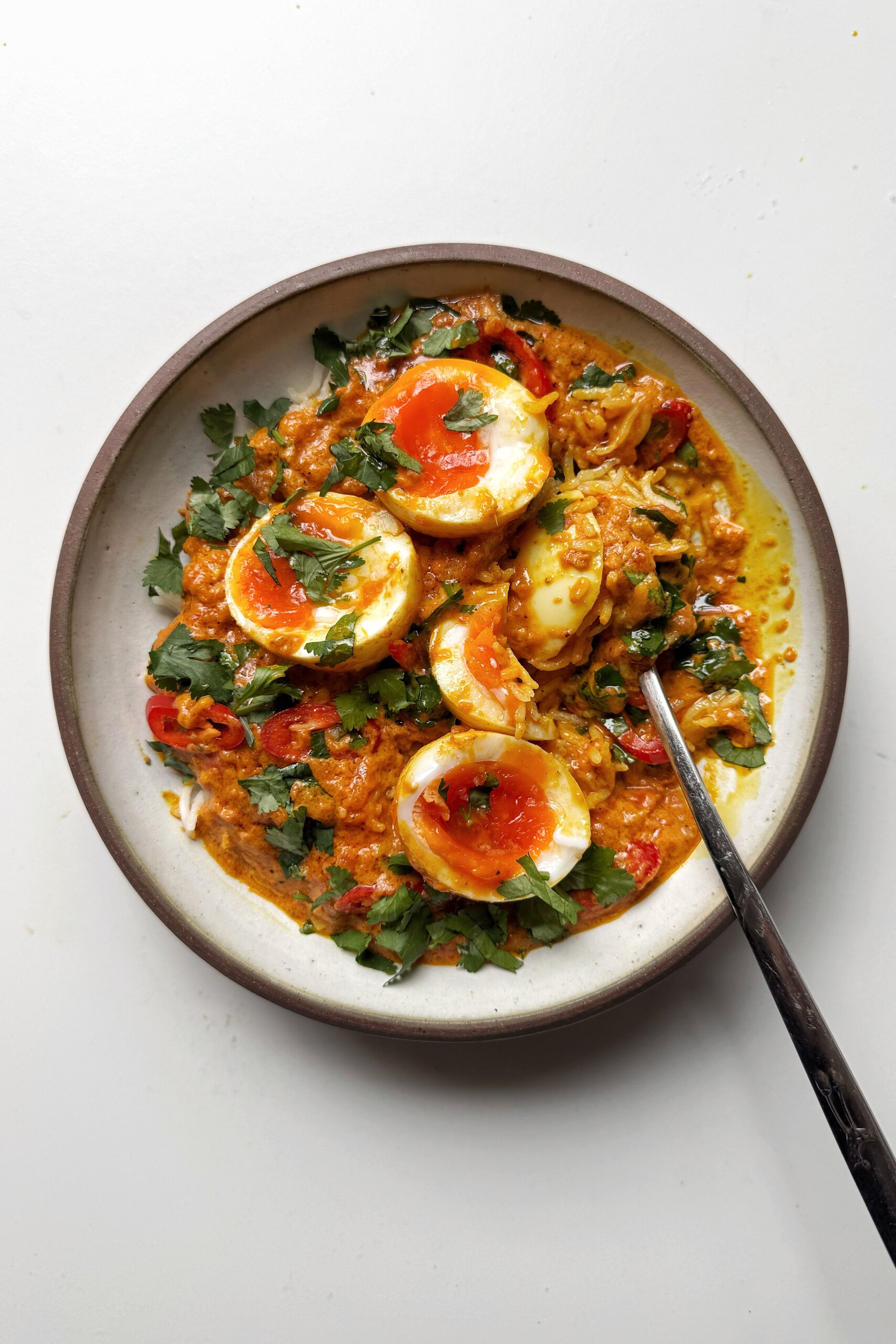 Eating egg curry in bowl.