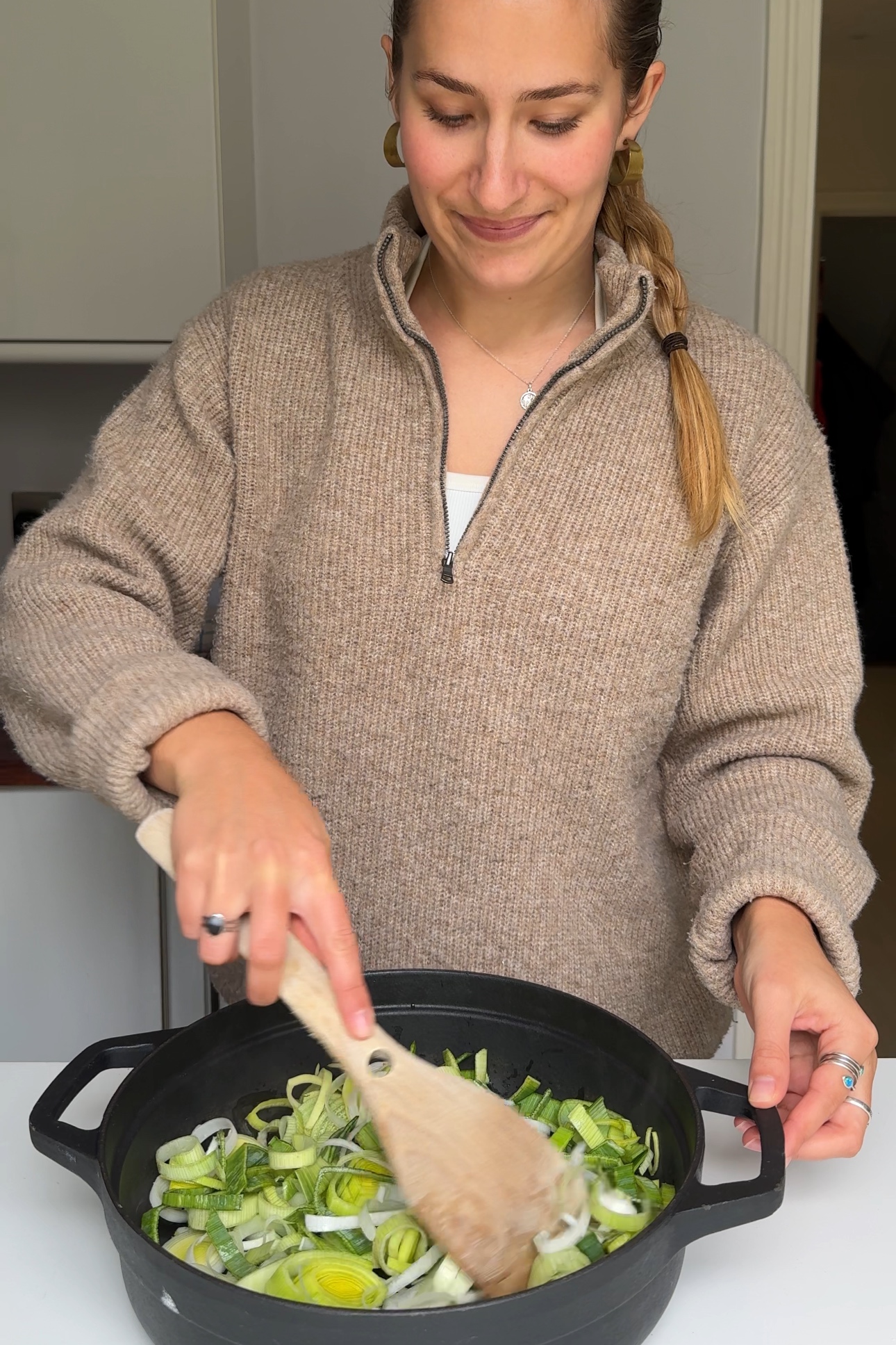 Frying up leeks in an oven-proof dish.
