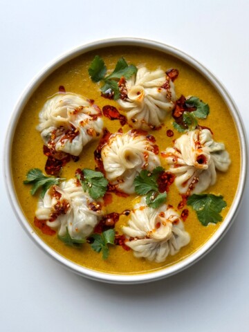 homemade Jhol momo in a white bowl.