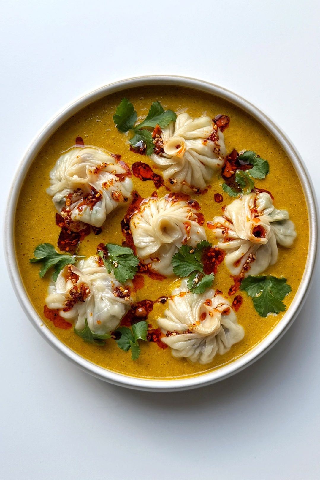 homemade Jhol momo in a white bowl.