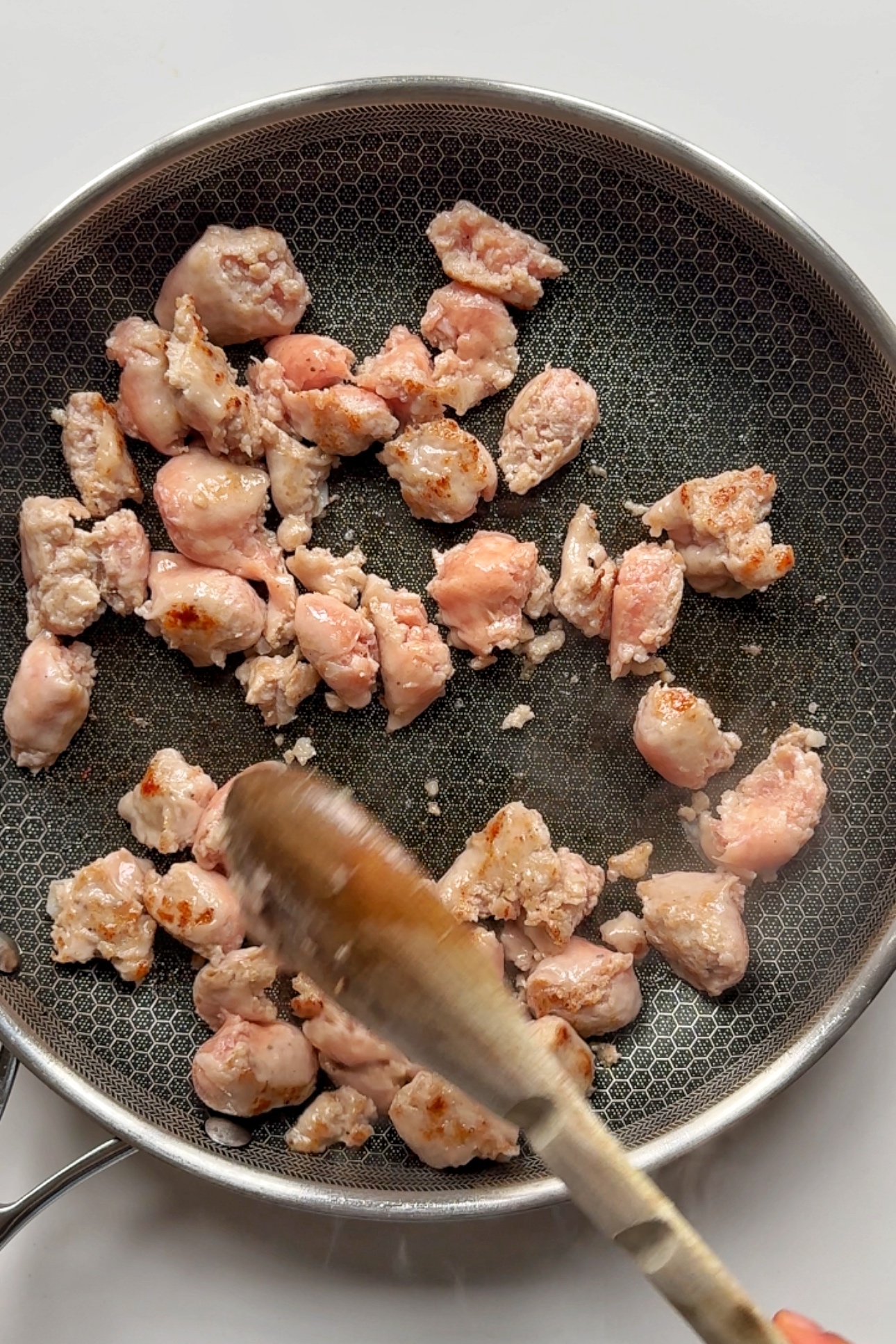 frying off sausage in a pan.