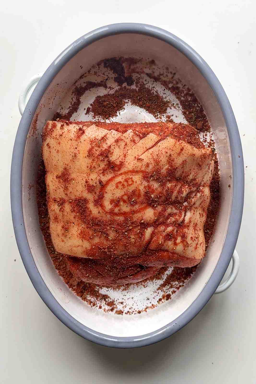 Pork joint in the tin with a spice mix rub.