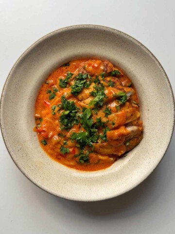 Chicken paprikash with noodles in bowl.