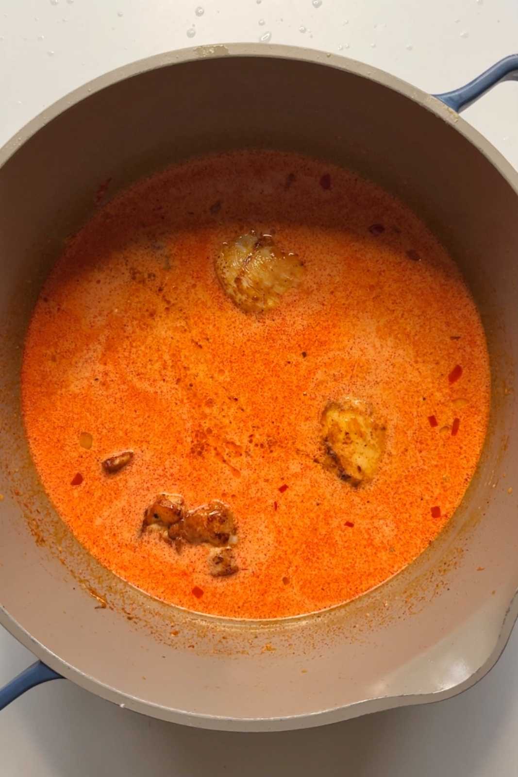 Cooking chicken in paprikash stew.