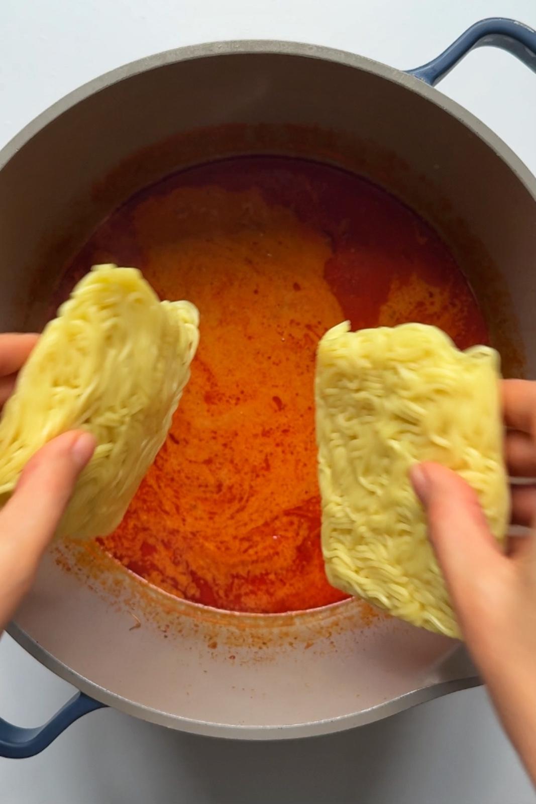 Adding noodles into paprikash stew.