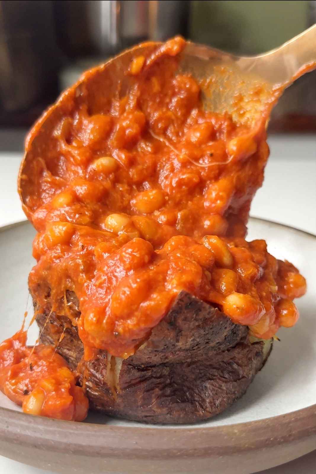 Serving up the beans on the jacket potato.