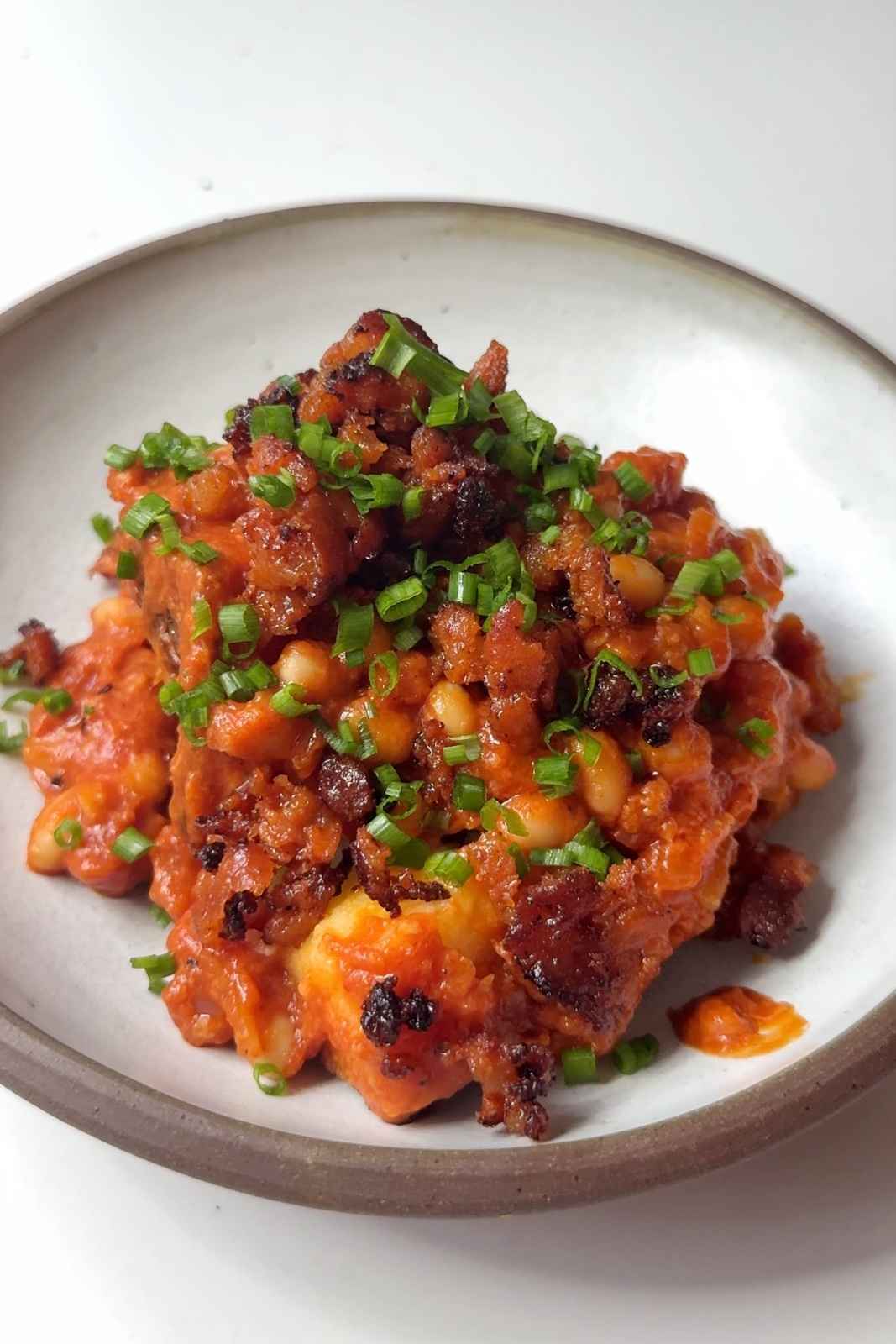 jacket potato topped with cheesy beans, fried chorizo and chives.