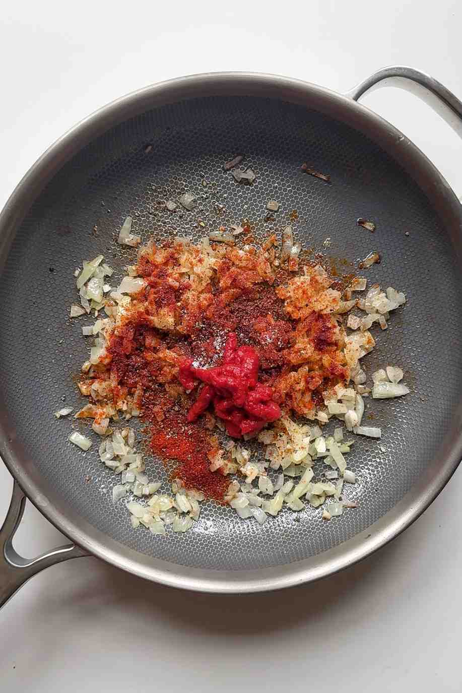 onion and garlic frying with tomato paste.