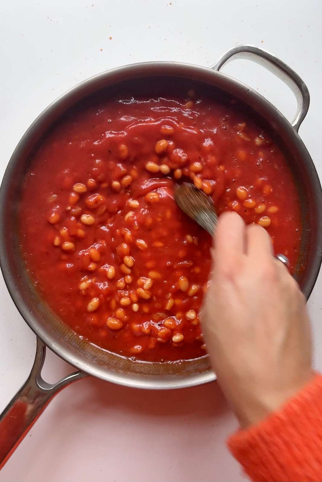 cooking homemade beans in a pan.