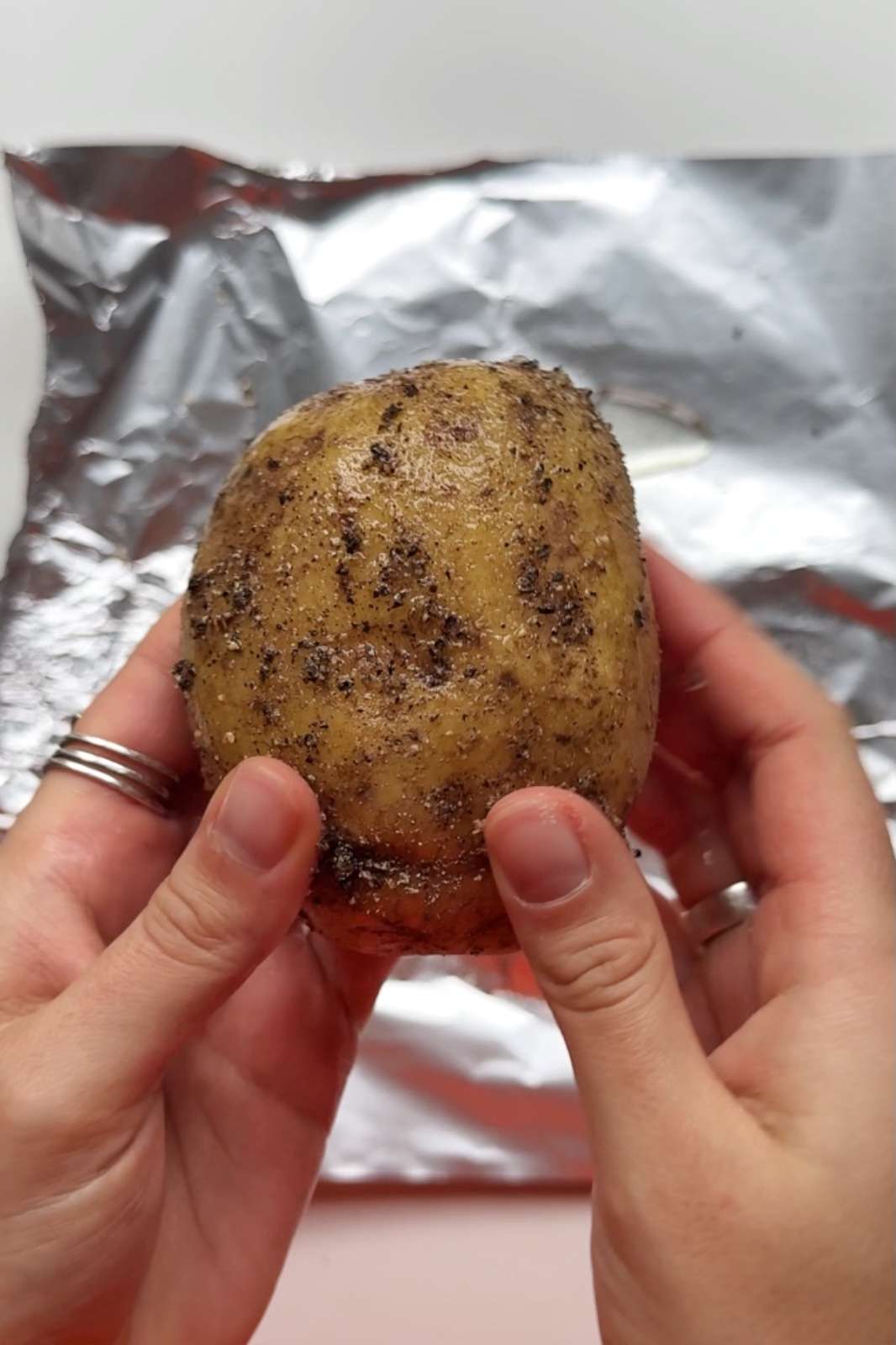 rubbing potato with salt and pepper.