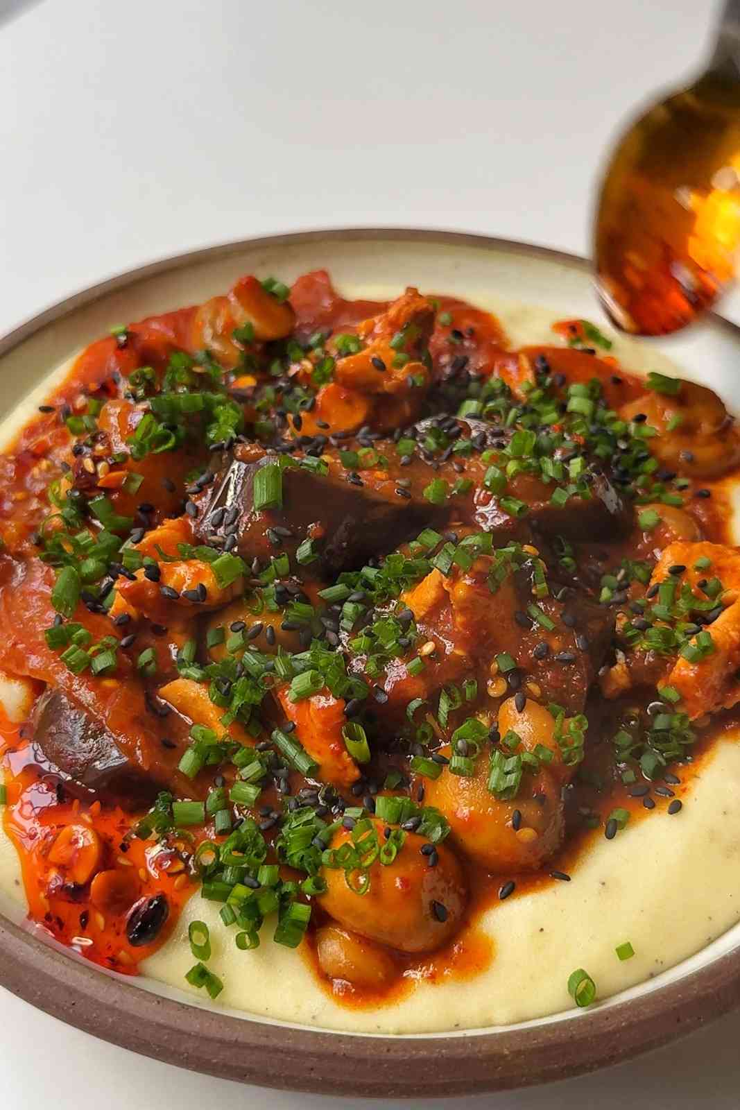 Drizzling chilli oil onto the korean style chicken stew.