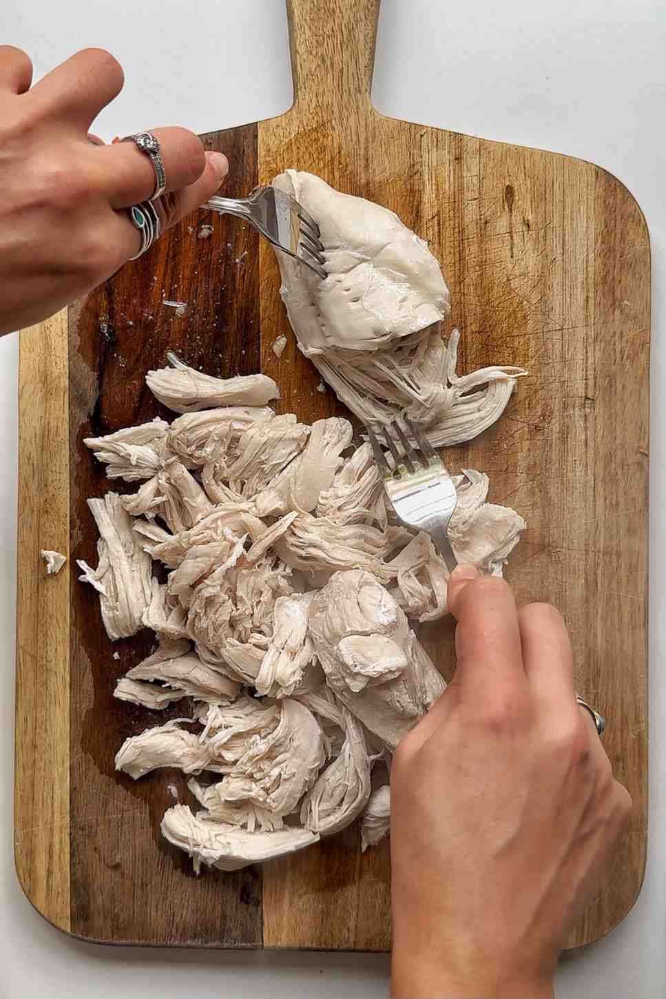 Shredding poached chicken.