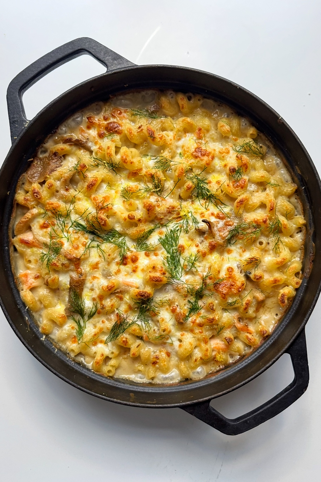 smoked salmon pasta bake in black pan.