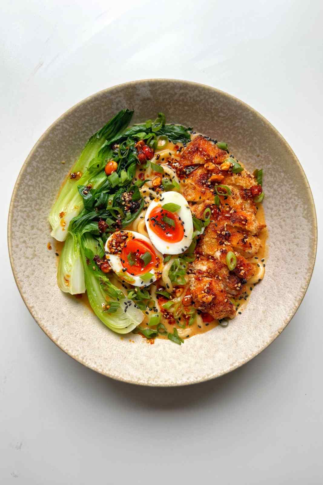 chicken katsu ramen in a cream bowl.