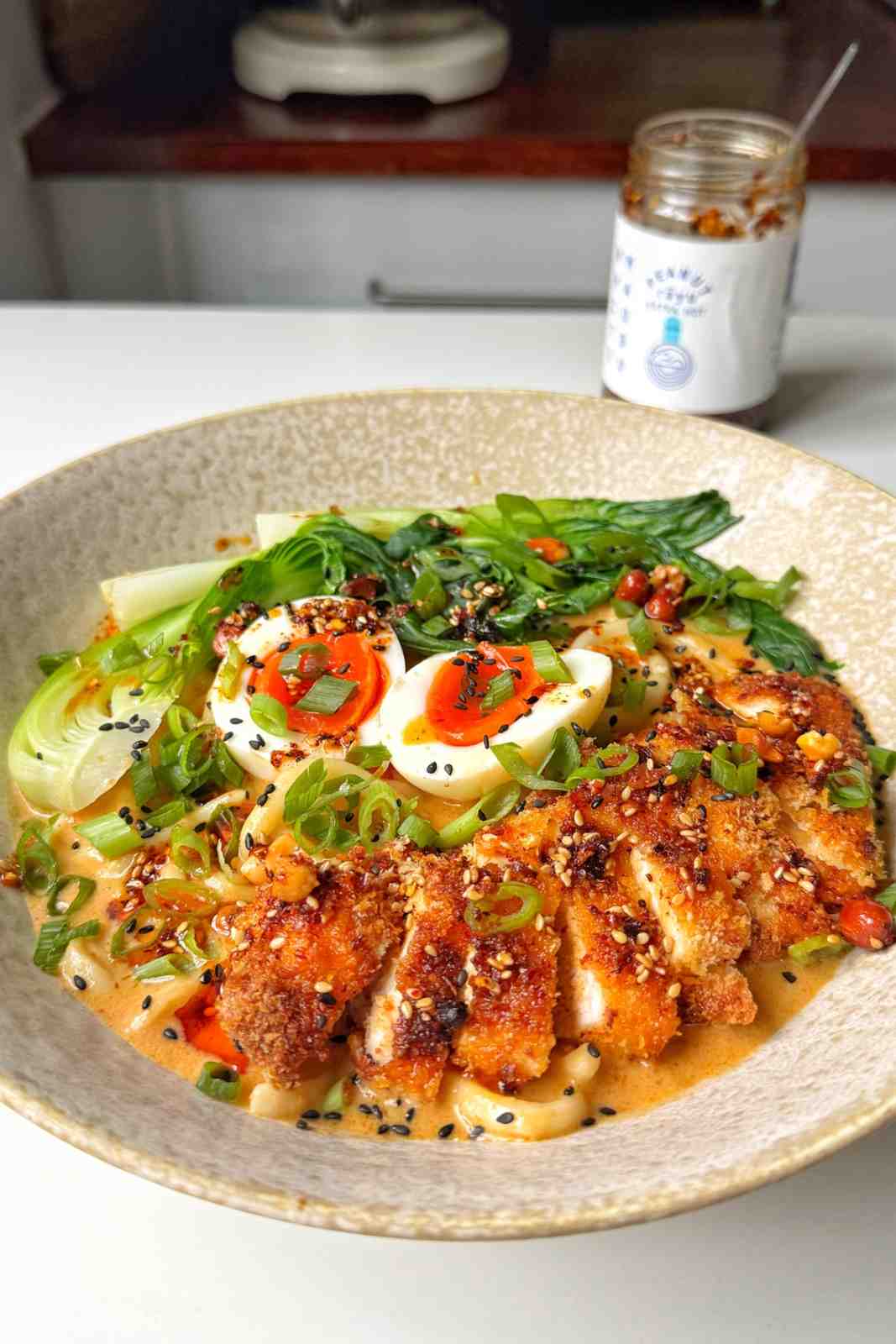 Chicken katsu ramen in a white bowl.