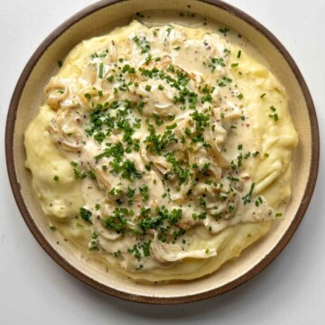 dijon mustard chicken on a bed of mashed potato.