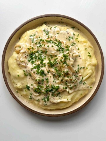 dijon mustard chicken on a bed of mashed potato.