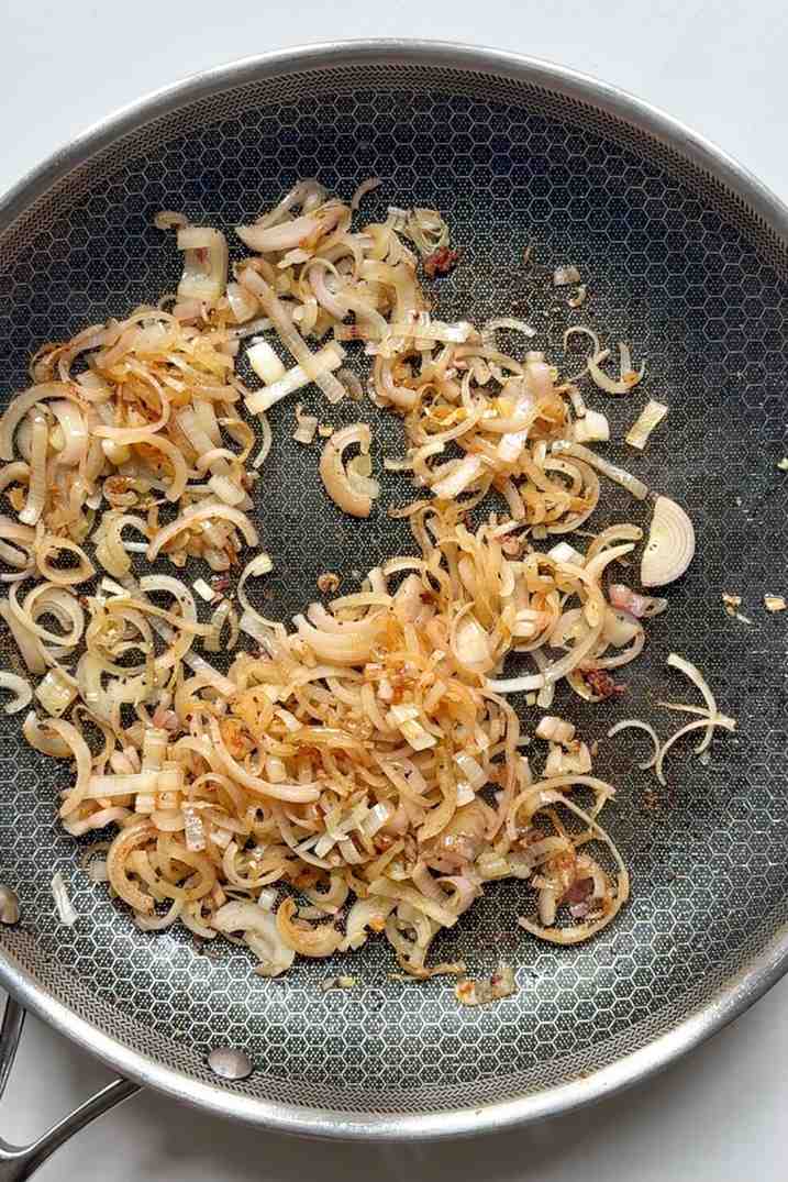 Frying shallots in a pan.