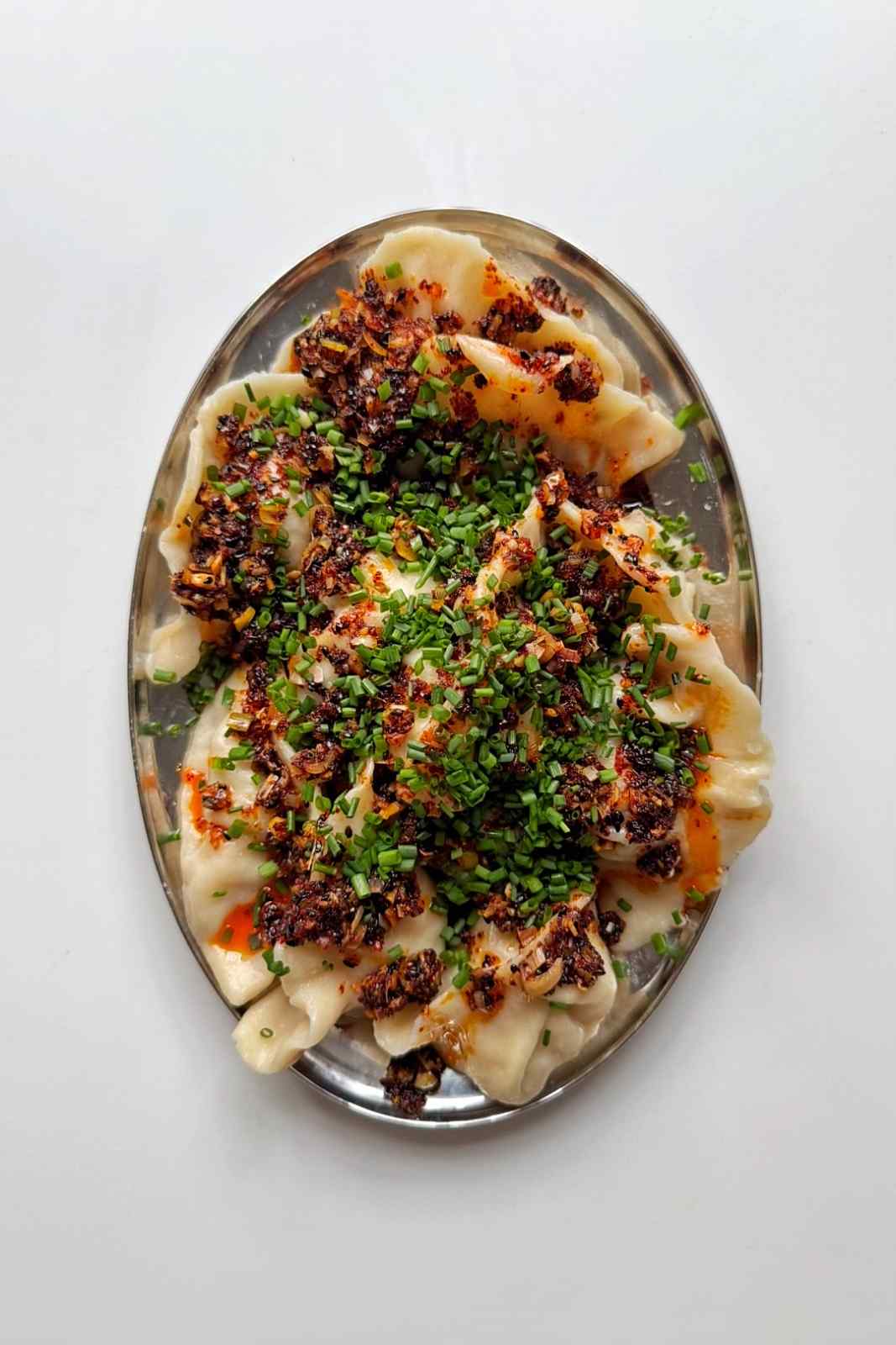 Pork and shrimp dumplings with lemongrass chilli oil and chives.