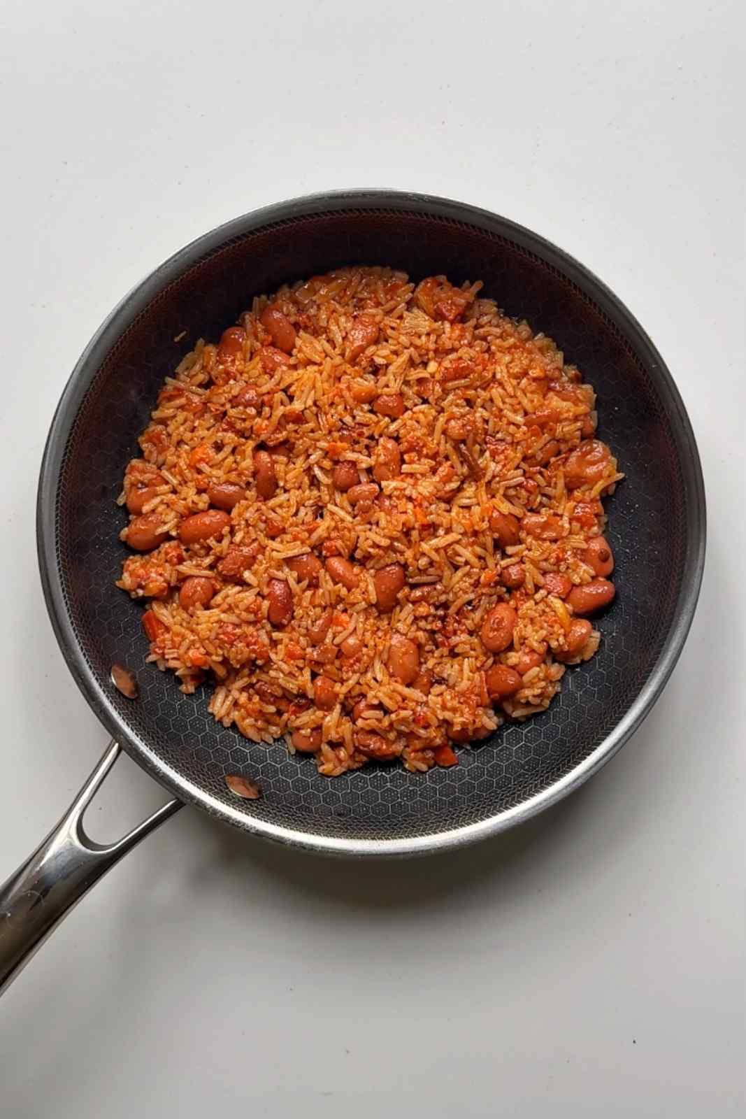 Frying rice and beans in a pan.