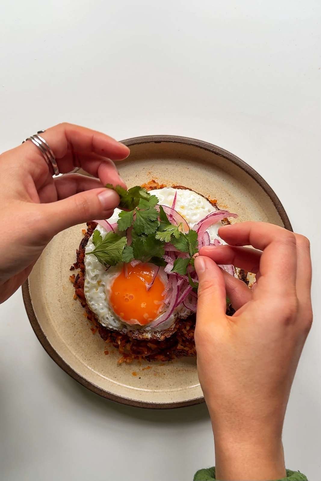 serving up tacu tacu on a plate.