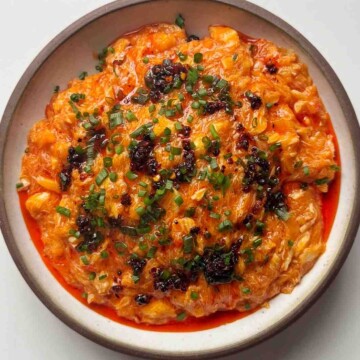 Chilli crab noodles in white bowl.