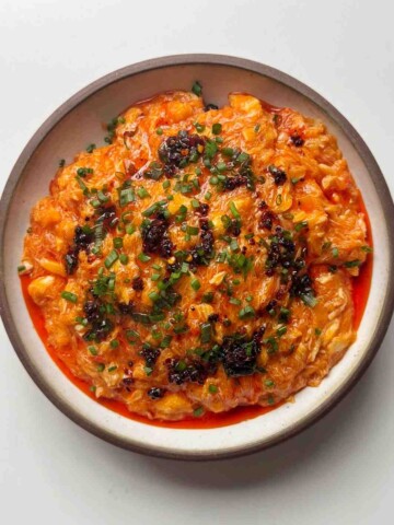 Chilli crab noodles in white bowl.