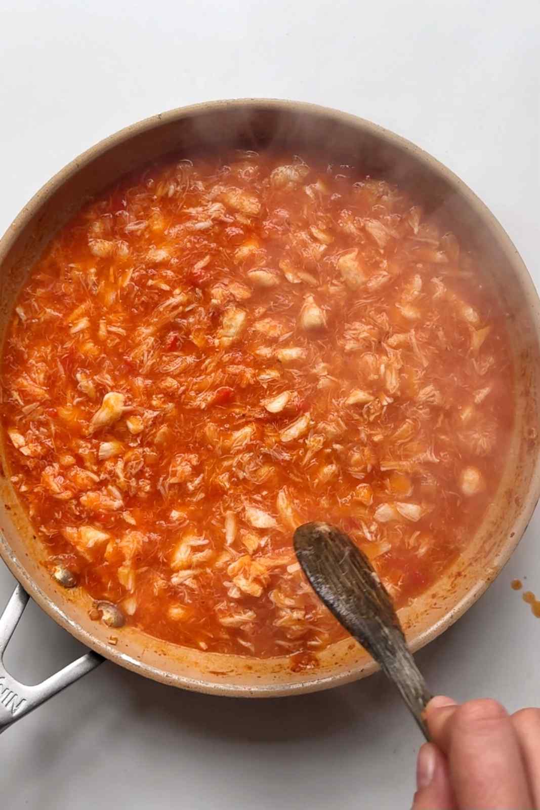 Stirring the chilli crab.