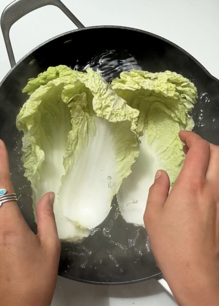 Napa cabbage being thrown into a boiling pan of water. A great bean sprout Substitute.