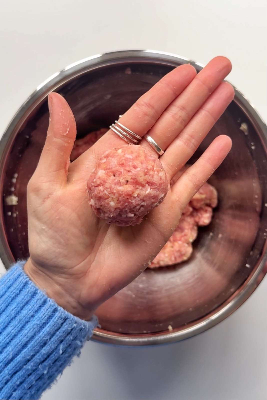 Homemade meatball in hand.