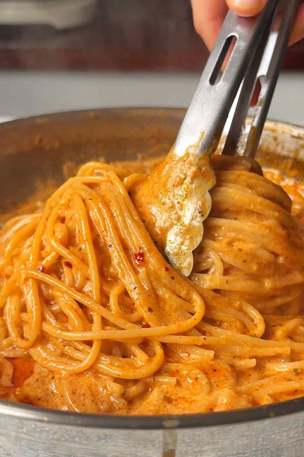 Swirling spicy Boursin pasta in a pan.