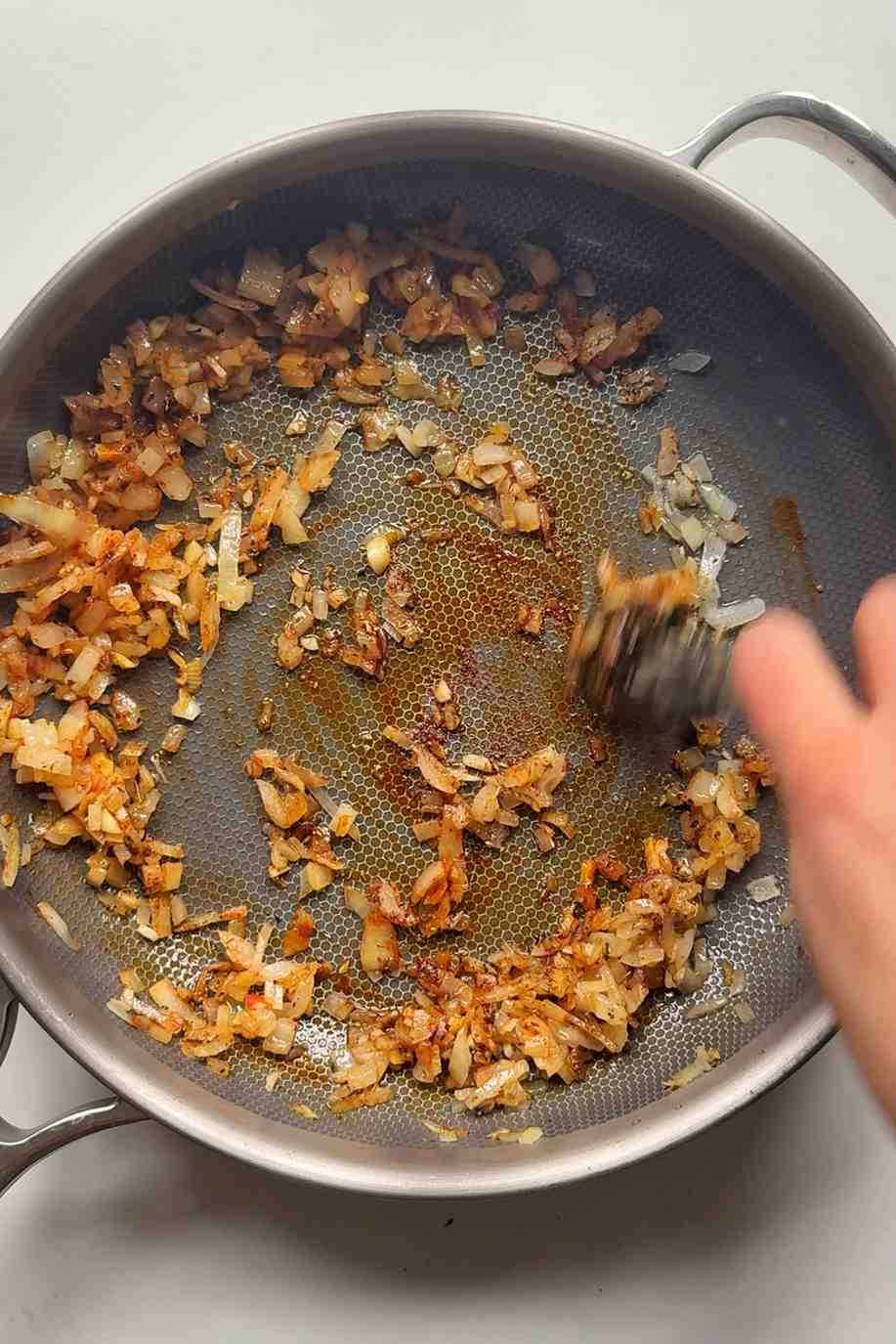 Frying garlic and onion in a pan.